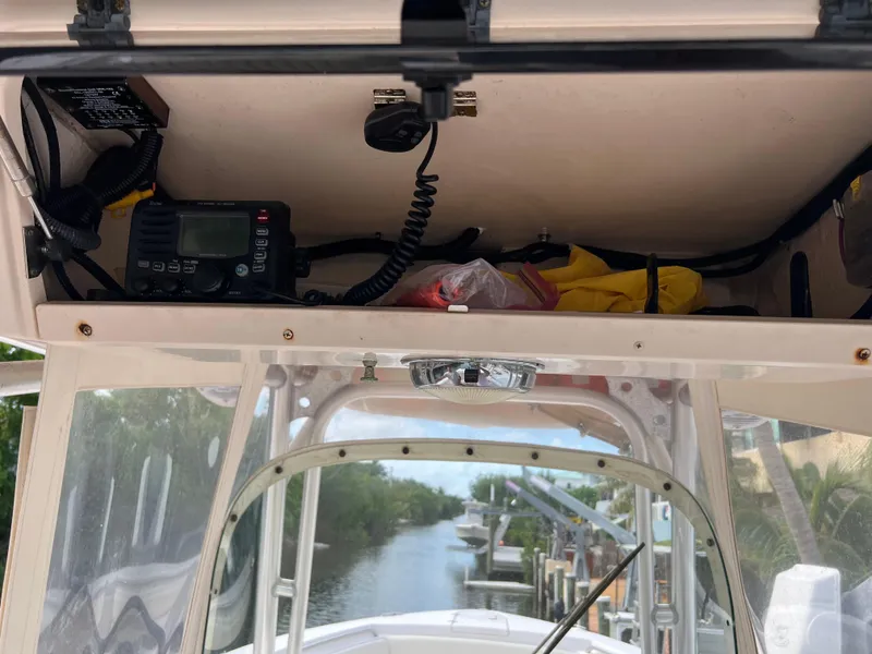 Slide: The Image of 2011 Grady-White Canyon 306 boat console with radio and storage compartment. - 12