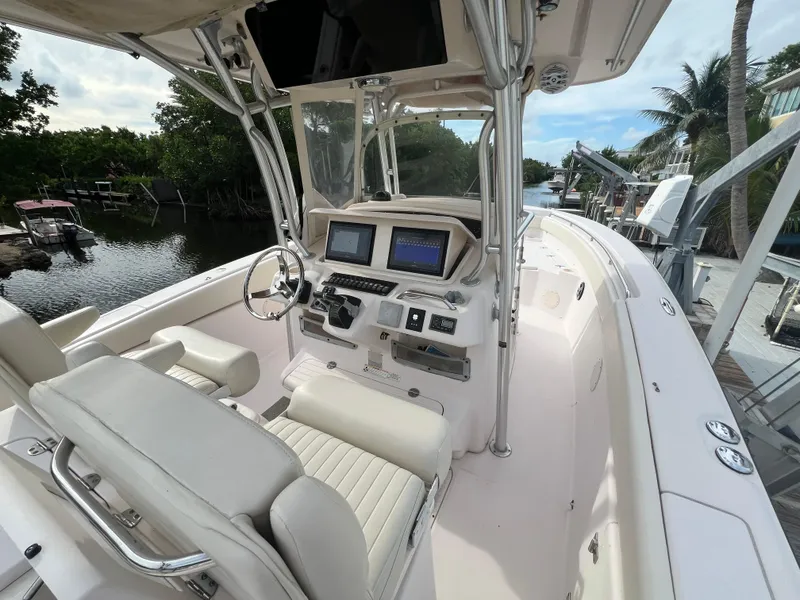 Slide: The Image of 2011 Grady-White Canyon 306 boat interior with dual screens and steering wheel. - 13