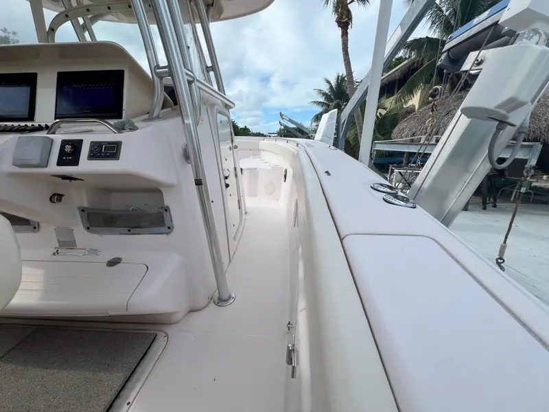Slide: The Image of 2011 Grady-White Canyon 306 boat interior with control panel and seating area. - 14