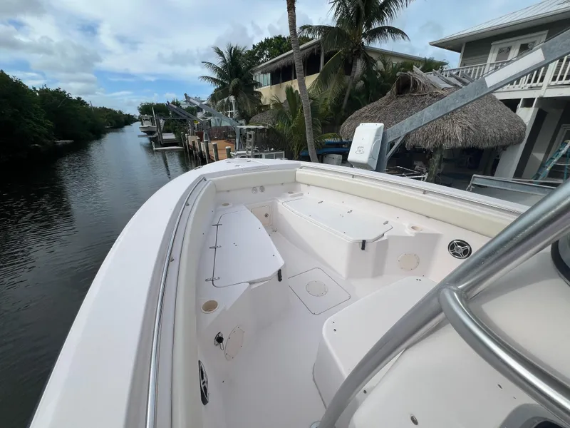 Slide: The Image of 2011 Grady-White Canyon 306 boat docked by a scenic canal with palm trees. - 16