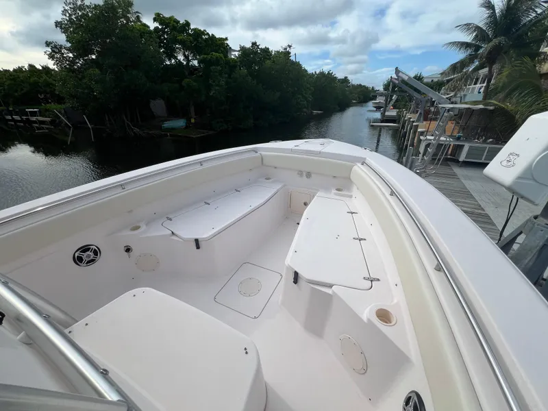 Slide: The Image of 2011 Grady-White Canyon 306 boat on a scenic waterway with lush greenery. - 17