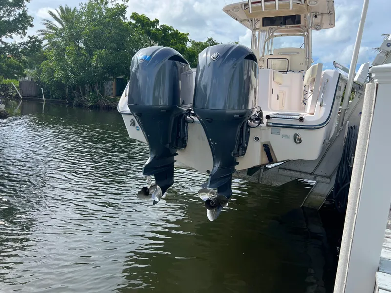 Slide: The Image of 2011 Grady-White Canyon 306 boat with dual outboard motors on a calm waterway. - 2