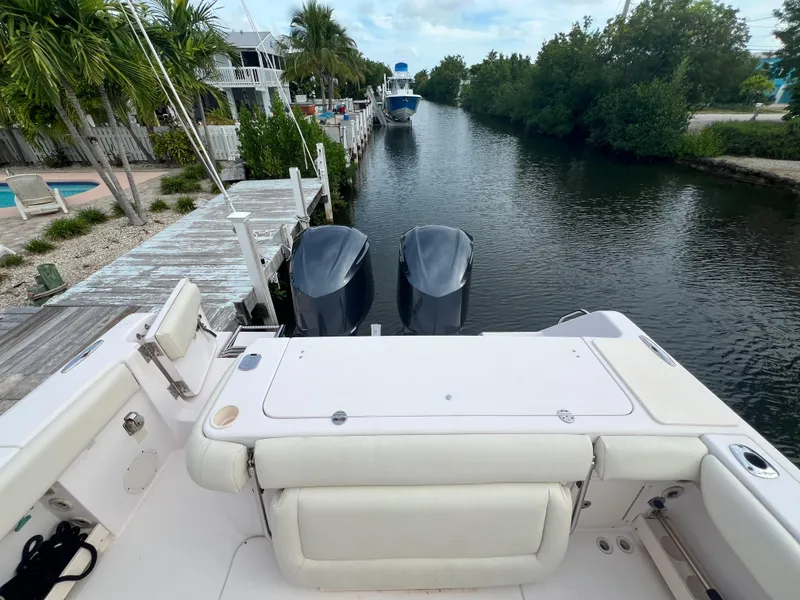 Slide: The Image of 2011 Grady-White Canyon 306 boat docked by a scenic canal with twin engines. - 5