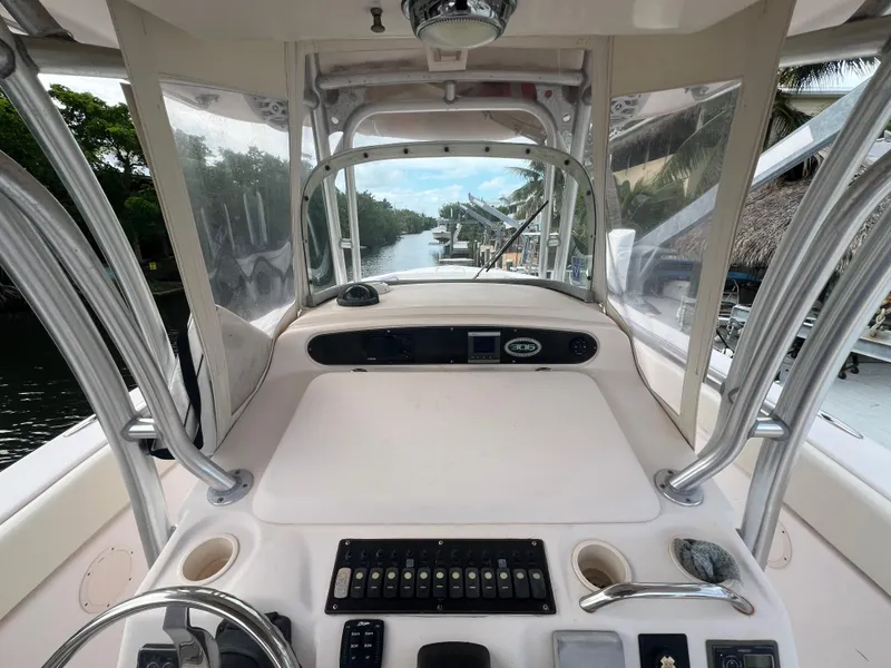 Slide: The Image of 2011 Grady-White Canyon 306 boat helm with controls and river view. - 8