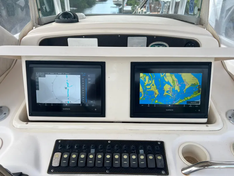 Slide: The Image of Grady-White Canyon 306 2011 boat dashboard with dual Garmin navigation screens. - 9
