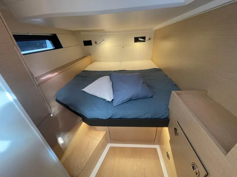 Slide: The Image of Cozy cabin interior of 2023 Hanse 460 yacht with bed and storage. - 11