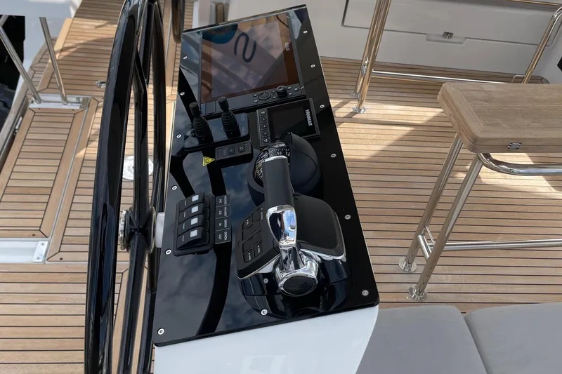 Slide: The Image of 2023 Hanse 460 yacht helm with modern controls and sleek design. - 15