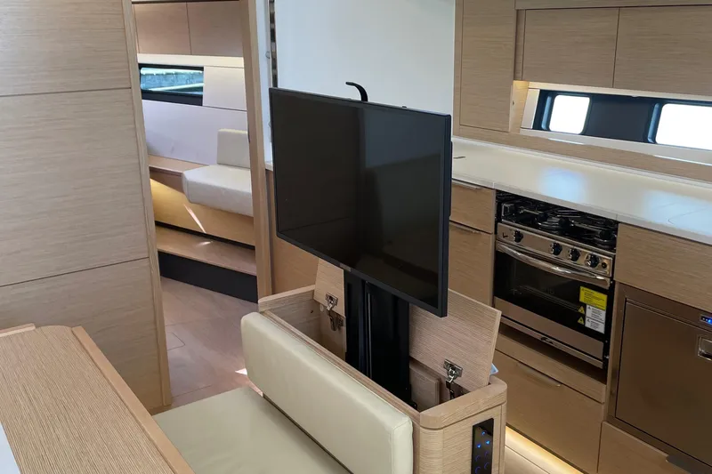 Slide: The Image of Modern interior of 2023 Hanse 460 yacht with TV, kitchen, and seating area. - 20
