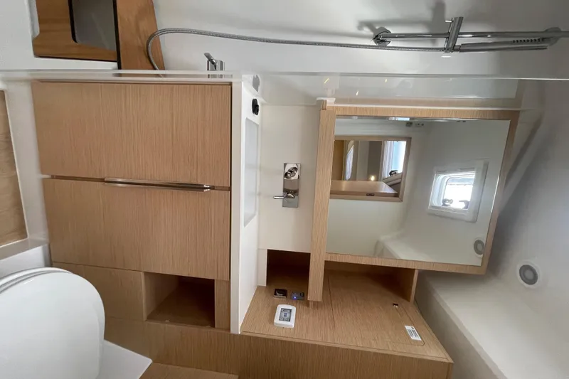 Slide: The Image of Modern bathroom interior of 2023 Hanse 460 yacht with wooden cabinetry and mirror. - 21