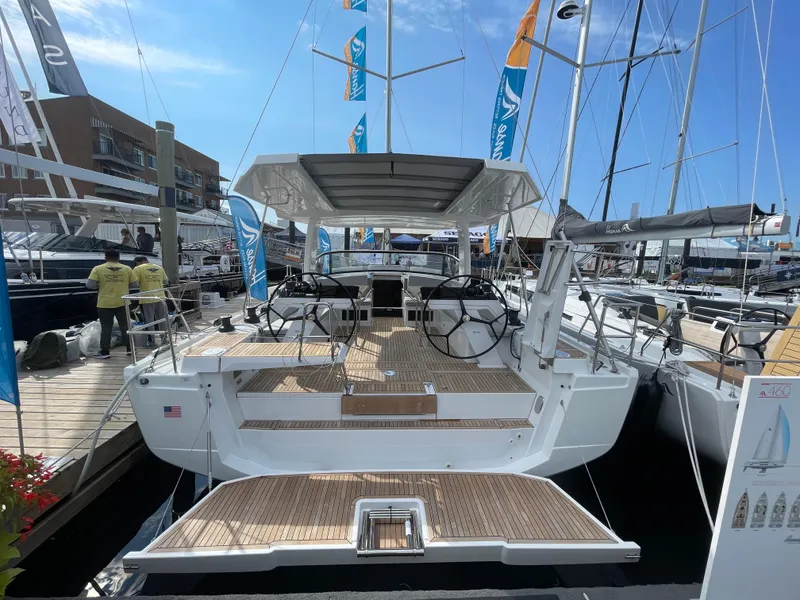 Slide: The Image of 2023 Hanse 460 yacht at marina, showcasing modern design and spacious deck. - 3