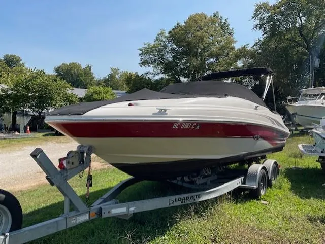 Slide: The Image of 2002 Sea Ray 220 Bow Rider on trailer, covered, parked on grass. - 0