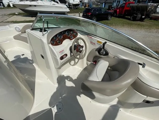Slide: The Image of 2002 Sea Ray 220 Bow Rider boat interior with steering wheel and dashboard. - 12