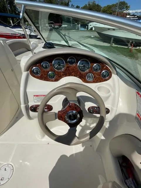 Slide: The Image of 2002 Sea Ray 220 Bow Rider dashboard with steering wheel and gauges. - 13