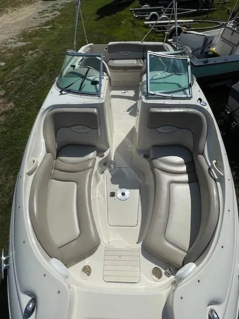 Slide: The Image of 2002 Sea Ray 220 Bow Rider with spacious seating and open deck design. - 16