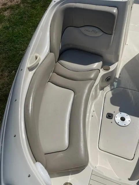Slide: The Image of 2002 Sea Ray 220 Bow Rider boat interior with beige seating. - 17