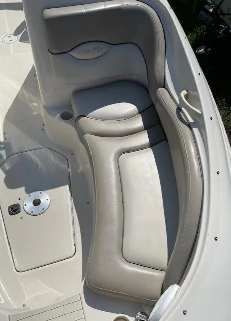 Slide: The Image of 2002 Sea Ray 220 Bow Rider interior with beige seating and sleek design. - 18