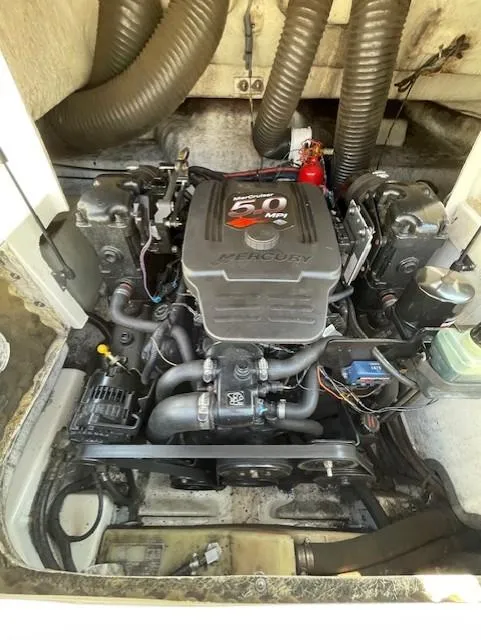 Slide: The Image of 2002 Sea Ray 220 Bow Rider engine compartment with 5.0L Mercury motor. - 22