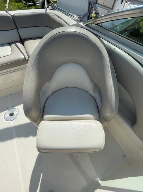 Slide: The Image of 2002 Sea Ray 220 Bow Rider boat seat, gray upholstery, spacious interior. - 8