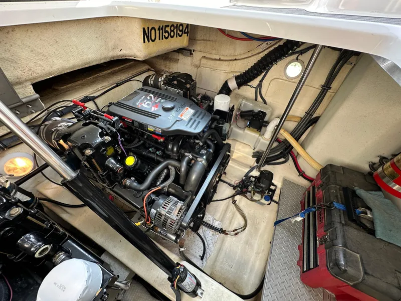 Slide: The Image of Engine compartment of a 2004 Formula 34 PC boat, showcasing mechanical components and wiring. - 30