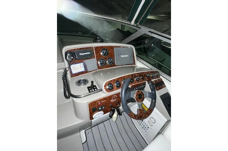 Slide: The Image of 2004 Formula 34 Performance Cruiser helm with Raymarine electronics and woodgrain dashboard. - 35