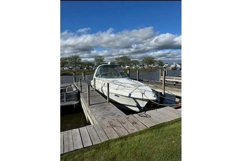 Slide: The Image of 2004 Formula 34 Performance Cruiser docked at a marina under a blue sky. - 38