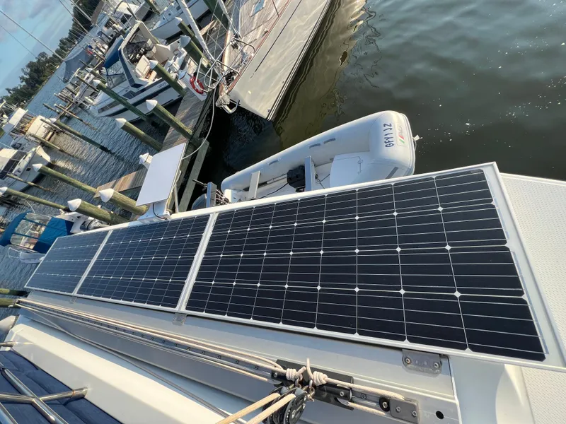 Slide: The Image of Solar panels on a 2020 Fountaine Pajot Elba 45 catamaran docked at a marina. - 13