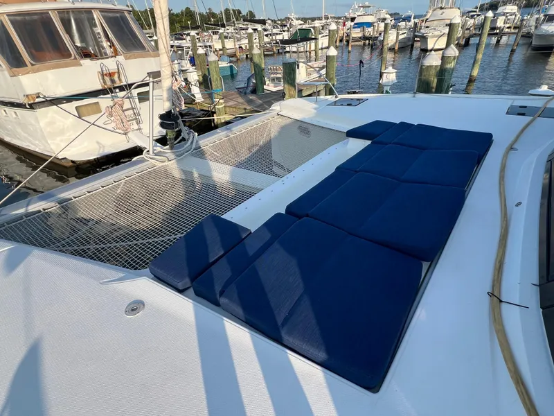 Slide: The Image of Fountaine Pajot Elba 45 catamaran with blue cushions, docked at a marina, 2020 model. - 14