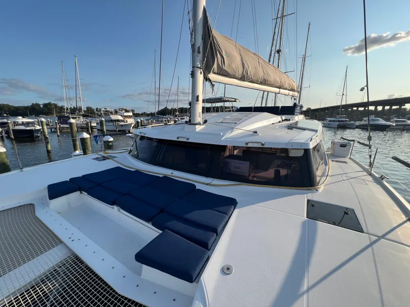 Slide: The Image of 2020 Fountaine Pajot Elba 45 catamaran docked at marina, featuring spacious deck and seating. - 15