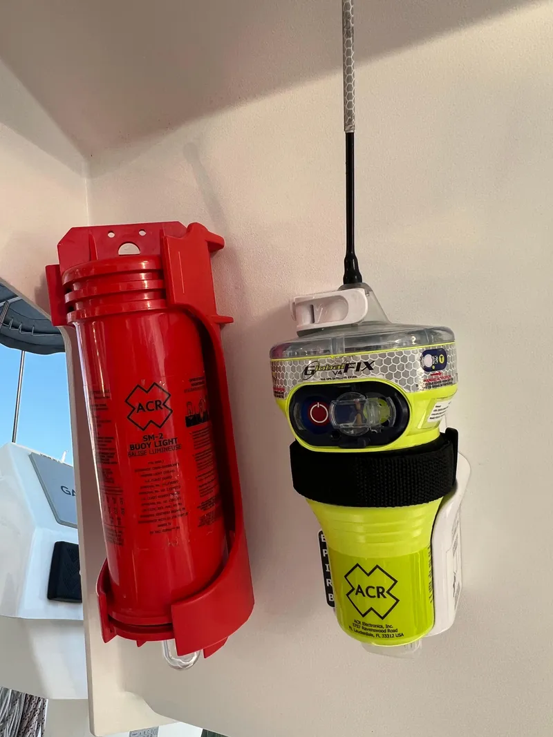 Slide: The Image of Safety equipment on a 2020 Fountaine Pajot Elba 45 catamaran, featuring an ACR EPIRB and fire extinguisher. - 19