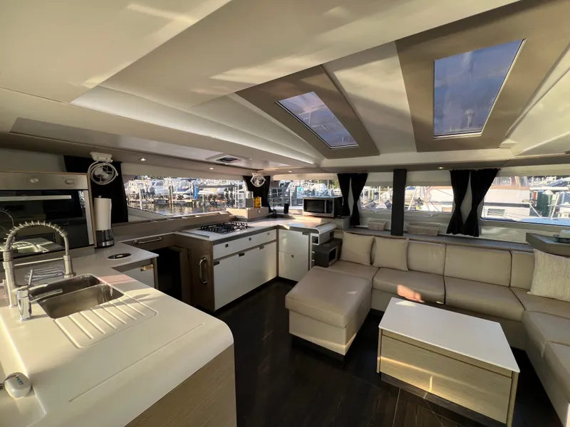 Slide: The Image of Luxurious interior of 2020 Fountaine Pajot Elba 45 catamaran with modern kitchen and seating area. - 23