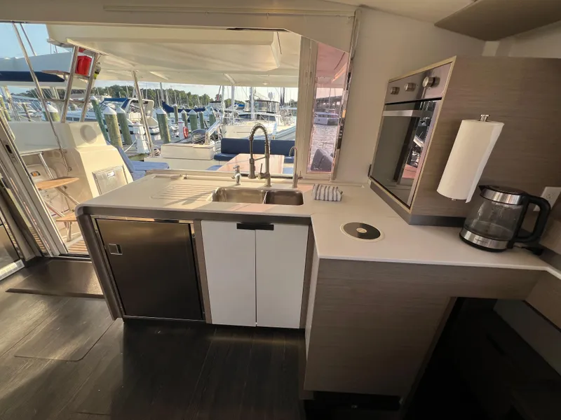 Slide: The Image of Modern kitchen interior of 2020 Fountaine Pajot Elba 45 catamaran with marina view. - 33
