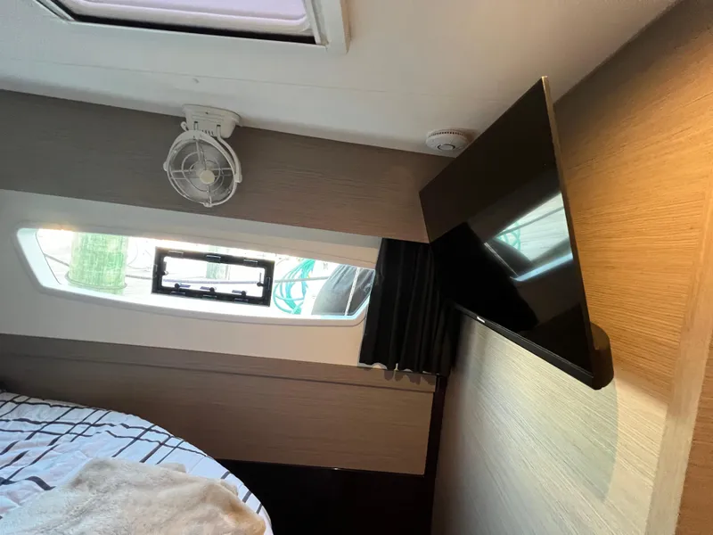 Slide: The Image of Interior of 2020 Fountaine Pajot Elba 45 with TV, window, and fan. - 34