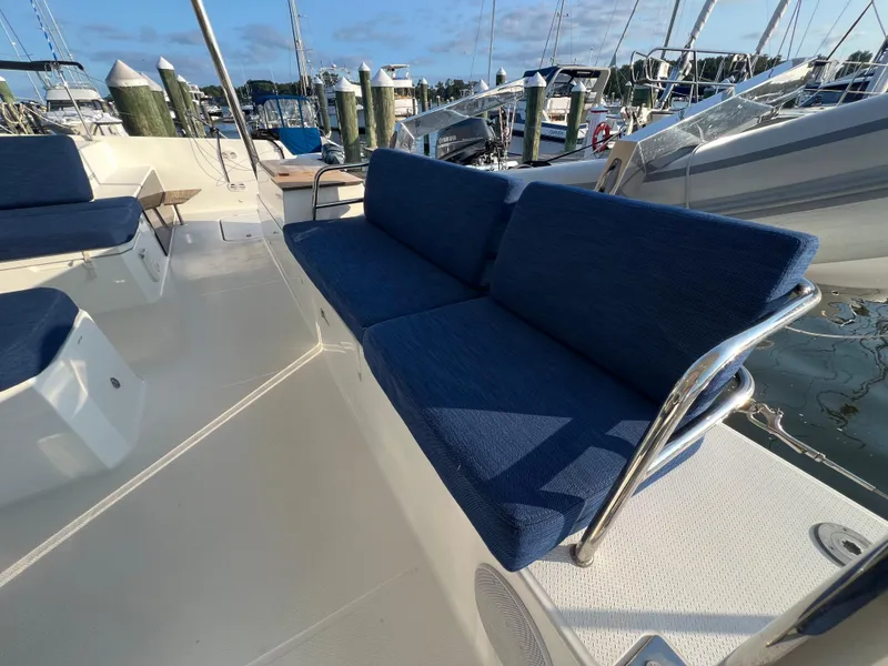 Slide: The Image of 2020 Fountaine Pajot Elba 45 yacht with blue cushioned seating on deck. - 7