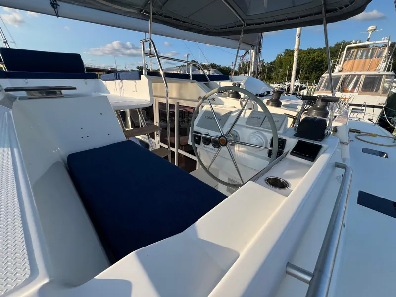 Slide: The Image of 2020 Fountaine Pajot Elba 45 yacht helm with blue seating and steering wheel. - 9