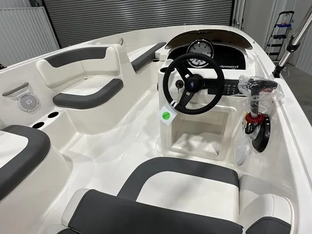 Slide: The Image of 2025 Bayliner Element E16 boat interior with steering wheel and seating. - 8