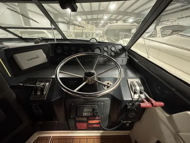 Slide: The Image of Cockpit of 1990 Sea Ray 420 Sundancer with steering wheel and control panel. - 20