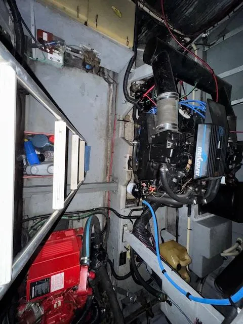 Slide: The Image of Engine room of 1990 Sea Ray 420 Sundancer with visible machinery and components. - 24