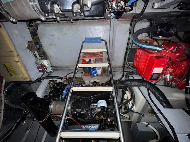 Slide: The Image of Engine room of a 1990 Sea Ray 420 Sundancer with visible components and ladder. - 25