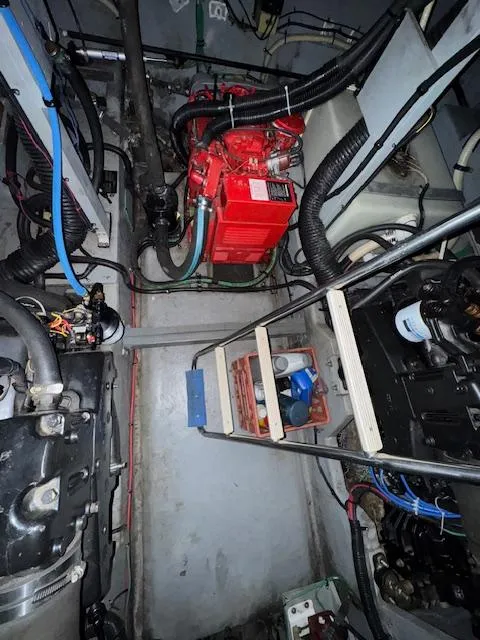 Slide: The Image of Engine room of 1990 Sea Ray 420 Sundancer with visible components and wiring. - 26