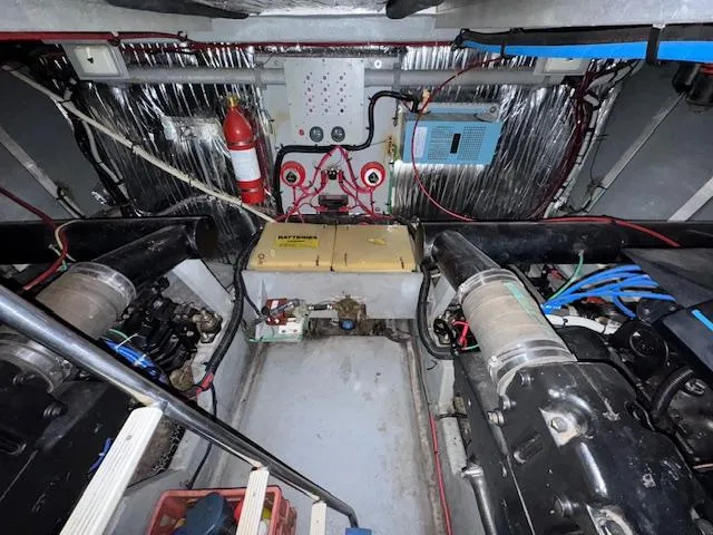 Slide: The Image of Engine room of 1990 Sea Ray 420 Sundancer with visible machinery and fire extinguisher. - 27