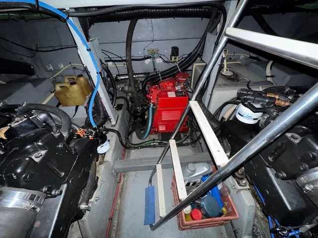 Slide: The Image of Engine room of 1990 Sea Ray 420 Sundancer with visible machinery and components. - 28