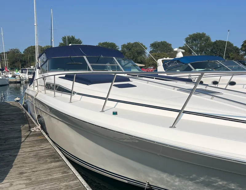 Slide: The Image of 1990 Sea Ray 420 Sundancer docked at marina under clear blue sky. - 3