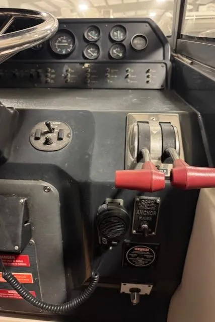 Slide: The Image of Control panel of a 1990 Sea Ray 420 Sundancer boat with throttle levers and gauges. - 30