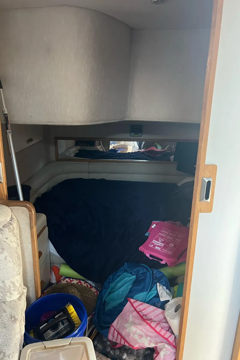 Slide: The Image of Interior cabin of 1990 Sea Ray 420 Sundancer with various items scattered. - 6