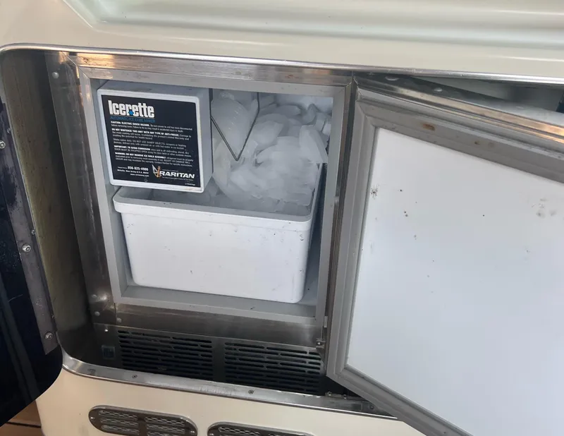 Slide: The Image of Ice maker inside 1990 Sea Ray 420 Sundancer yacht, open door showing ice compartment. - 7