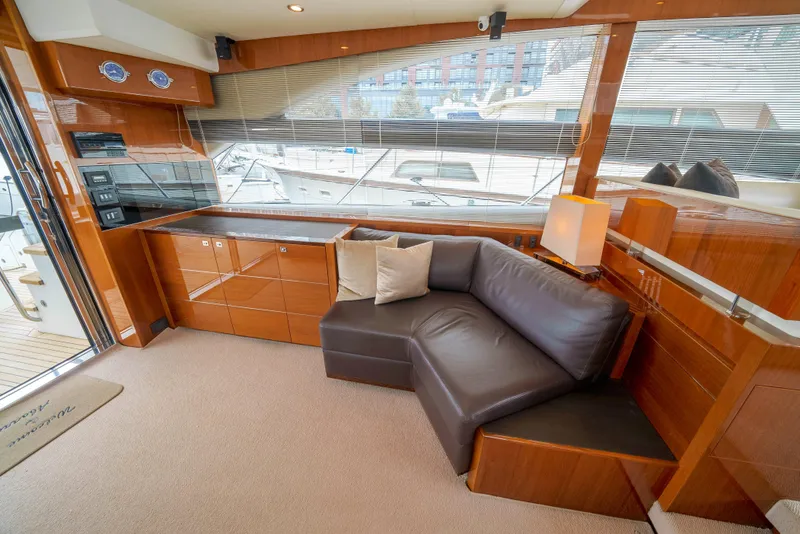 Slide: The Image of Luxurious interior of 2012 Princess Flybridge 60 Motor Yacht with leather seating and wood finishes. - 11