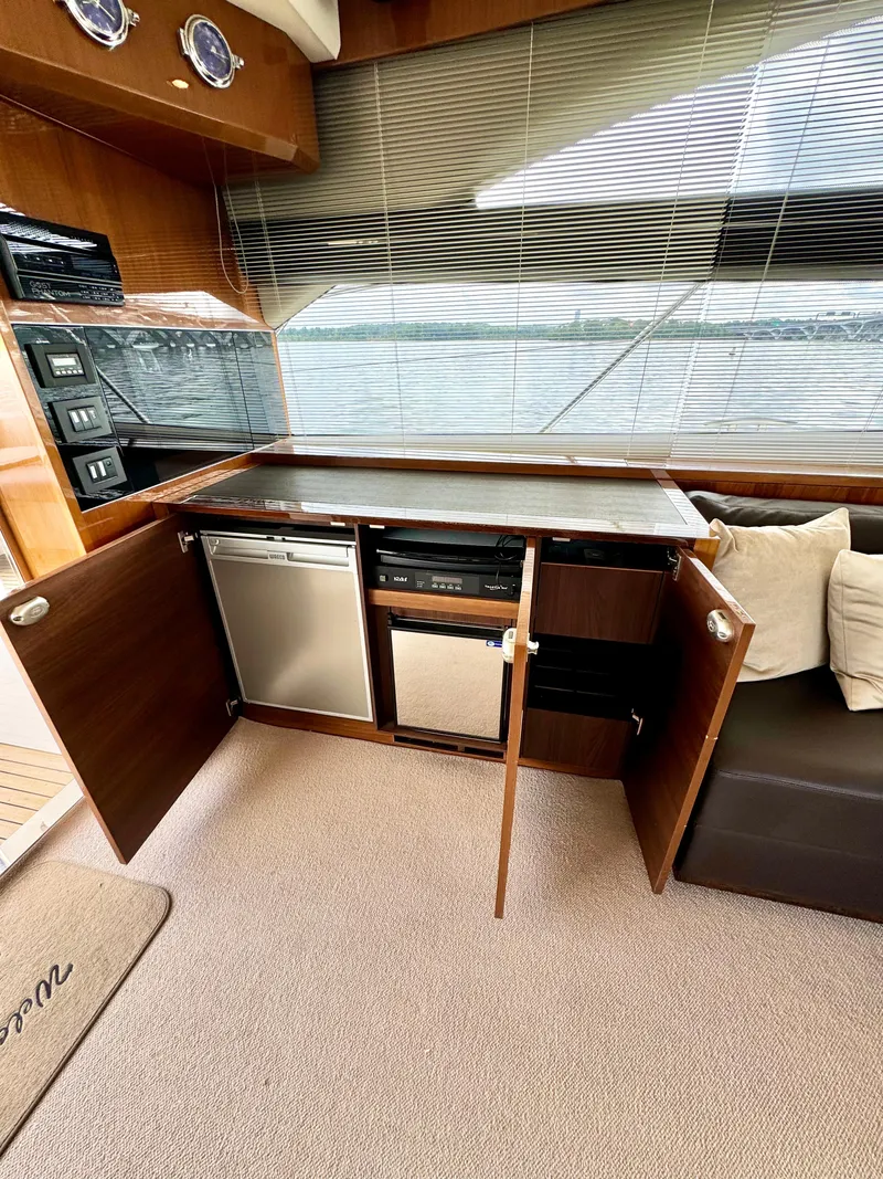 Slide: The Image of Interior of 2012 Princess Flybridge 60 Yacht with open cabinets and modern appliances. - 15