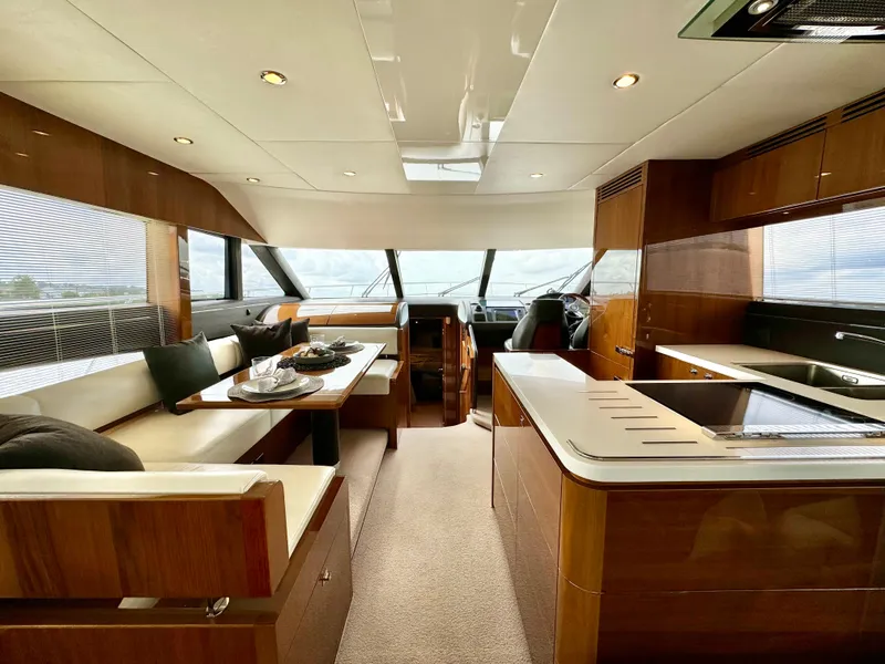 Slide: The Image of Luxurious interior of 2012 Princess Flybridge 60 Motor Yacht with modern kitchen and seating area. - 17