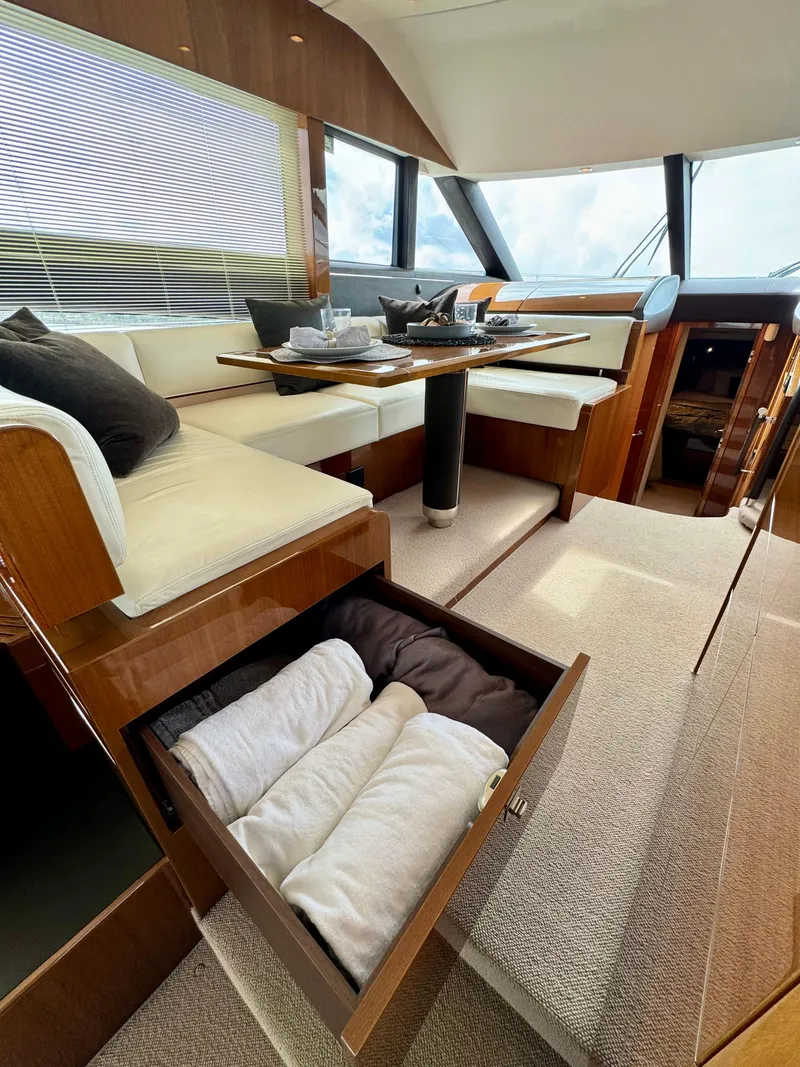 Slide: The Image of Luxurious interior of 2012 Princess Flybridge 60 Motor Yacht with seating and storage. - 18