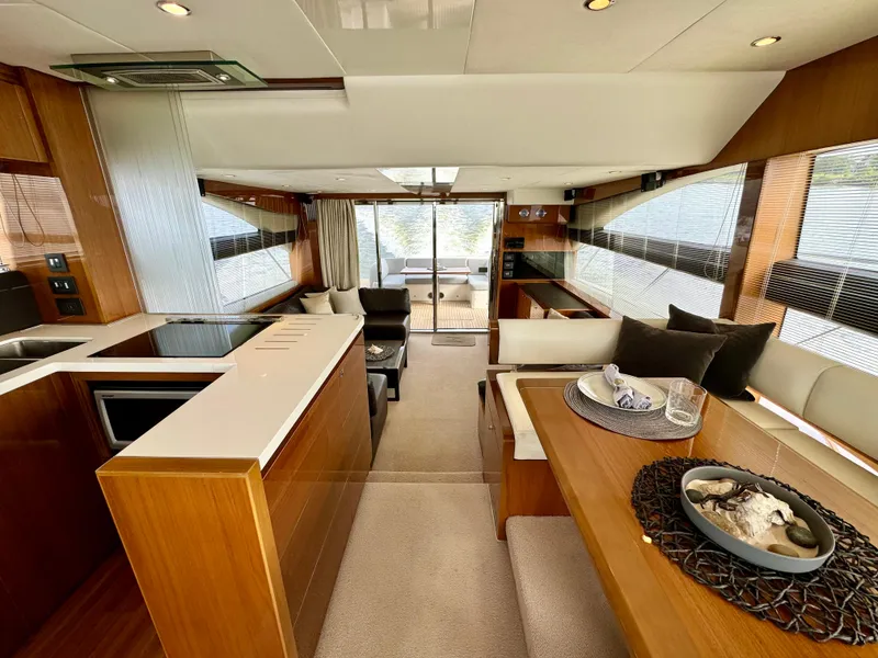 Slide: The Image of Luxurious interior of 2012 Princess Flybridge 60 Motor Yacht with modern kitchen and dining area. - 19